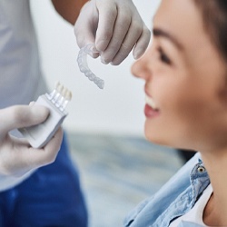 Invisalign dentist in Cumming testing aligner on patient 