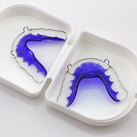 Two retainers laying inside a protective case to keep them safe from accidental damage