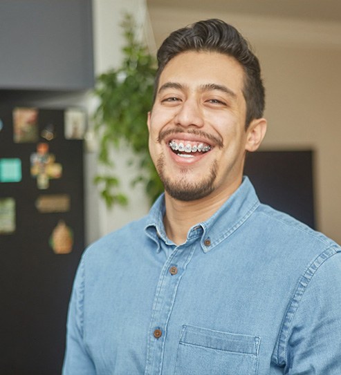 Happy adult man with braces