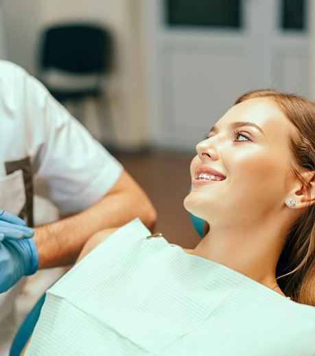 Patient with braces smiling at her orthodontist