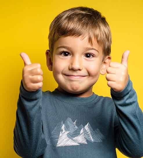 Happy toddler making double thumbs-up gesture