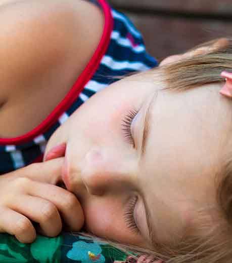 Little girl sucking on her finger while asleep