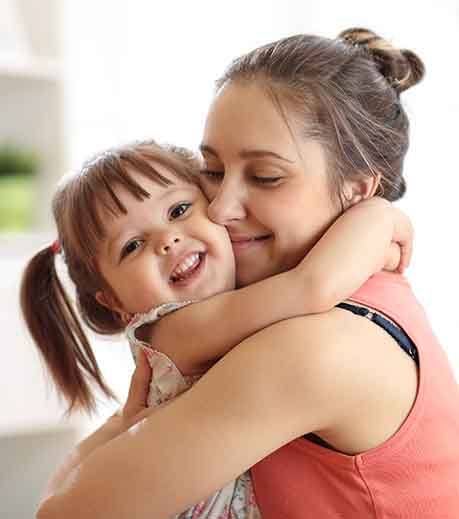 Happy little girl hugging her mother