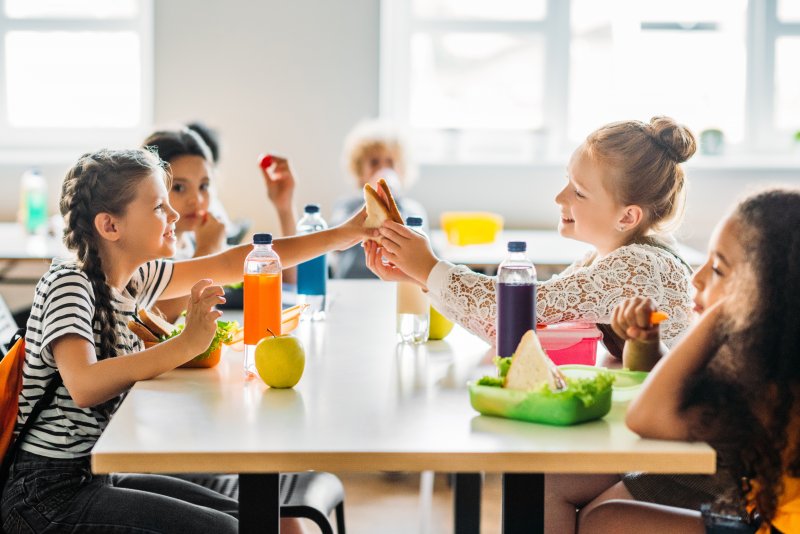 Group of school children eating lunch