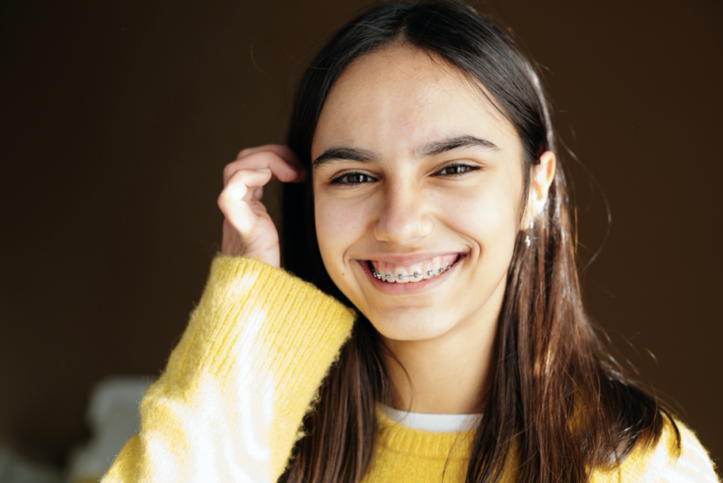 girl smiling with braces from an orthodontist in Cumming