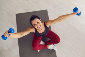 woman smiles while exercising 