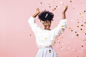 Excited woman celebrating New Year’s Eve after braces