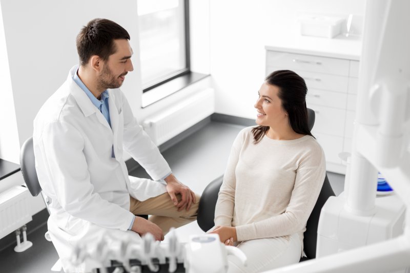 person smiling while talking to orthodontist