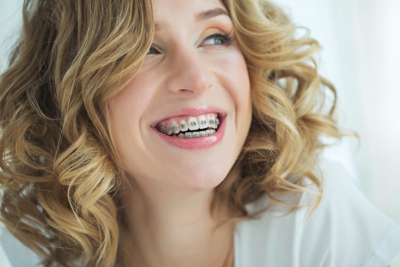 Woman smiles with braces