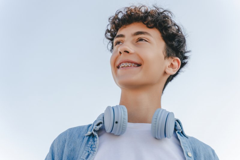 a teenager smiling with traditional braces