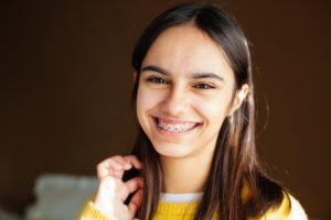 a smiling teenager with braces