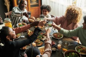 a family toasting before eating holiday dinner