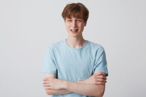 teen boy with braces looking insecure