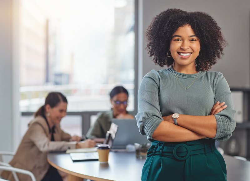 a woman wearing clear aligners to work 