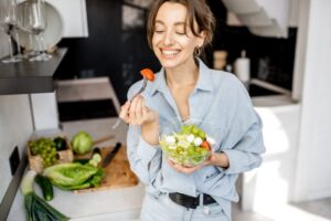 Smiling woman eating a healthy smile
