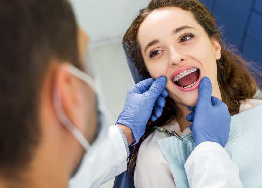 Girl with braces at orthodontic appointment