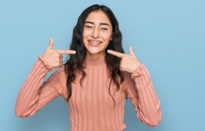 Woman pointing to her braces