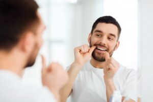 Man flossing during his Invisalign treatment